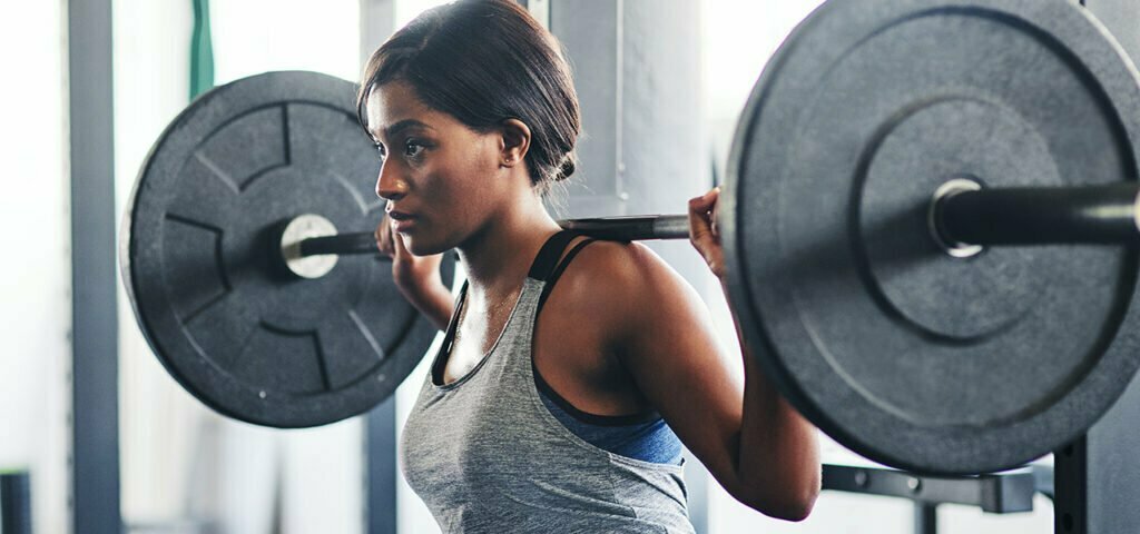 Young Caucasian man treating muscle soreness at the gym