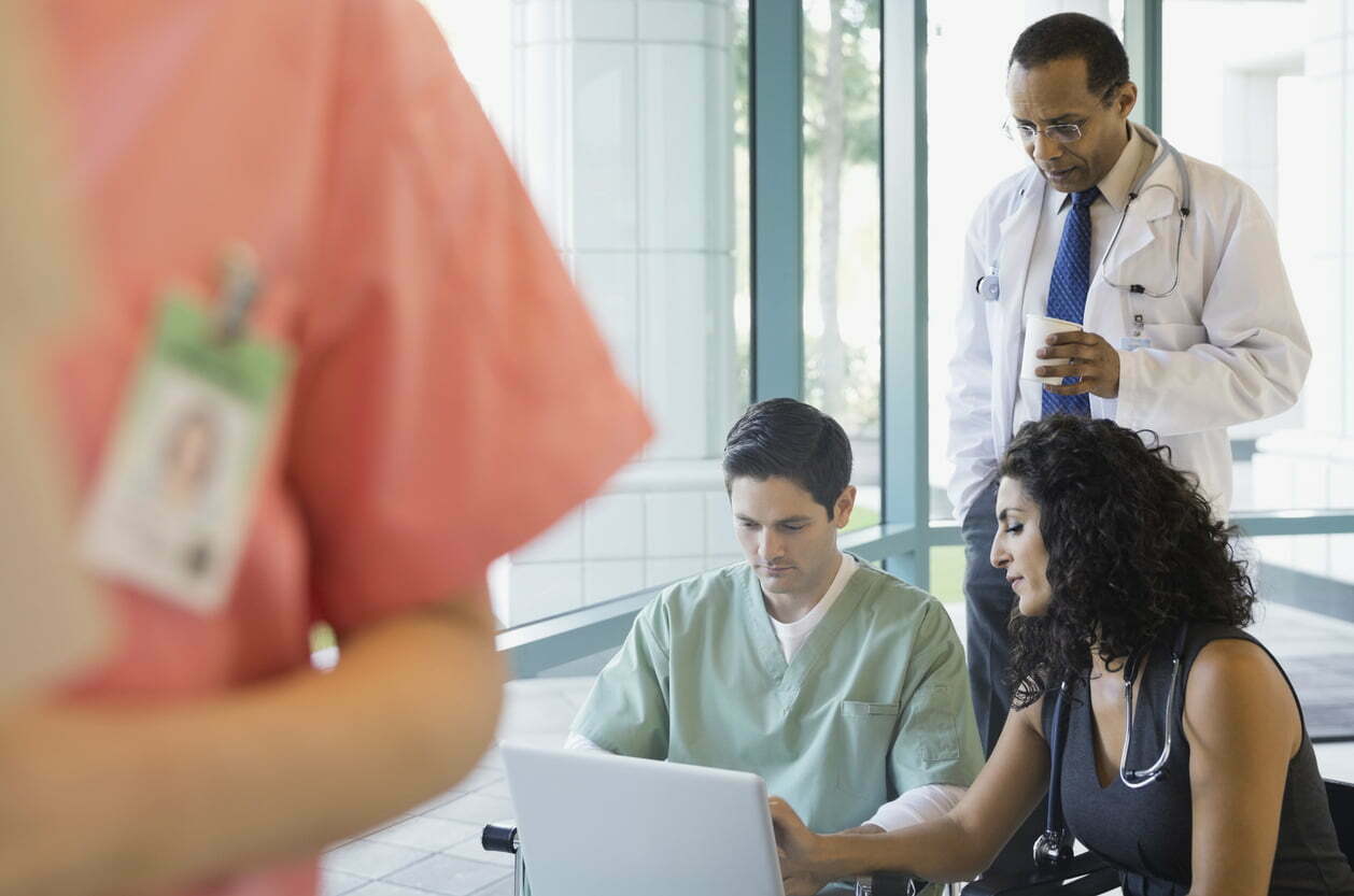 Healthcare team using laptop in a clinic