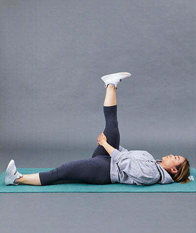 A woman performing a hamstring stretch