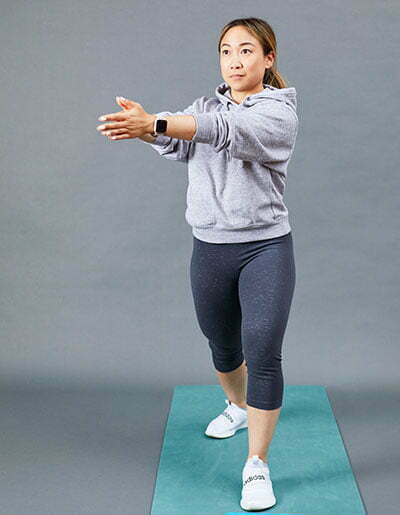 A woman performing a hip flexor stretch
