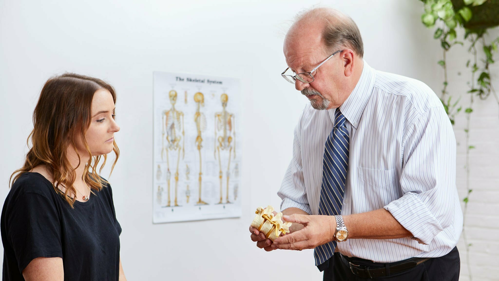 Chiropractor presenting a spine model